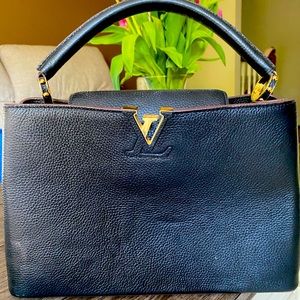 Louis Vuitton black leather pink interior.